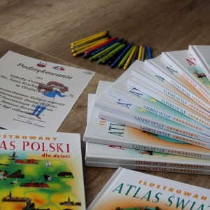 Ilustrowane Atlasy Polskie dla dzieci ułożone na stole.