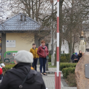 Grupka mieszkańców gminy Grabów stoi na chodniku.